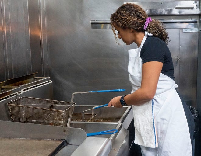 Mebruka Kane, chef, and co-owner, puts fries in the deep fryer at Doro Bet in Philadelphia on Wednesday, Dec. 20, 2023.

Daniella Heminghaus